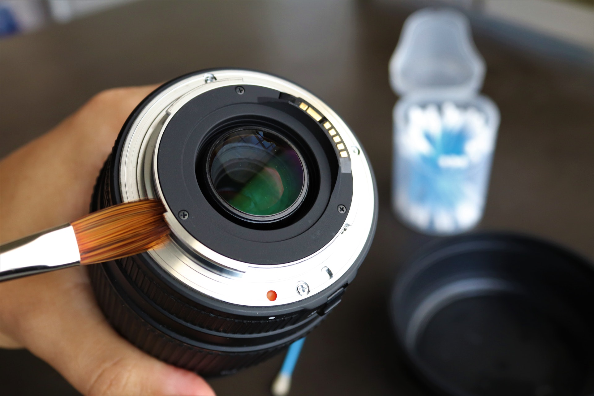 lens cleaning with a brush